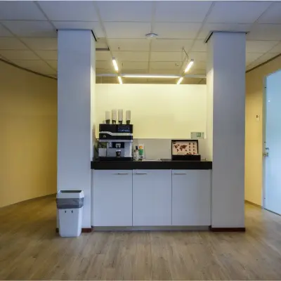 Office space at Bredewater 26, Zoetermeer, featuring a coffee station with cabinets and a trash bin, ideal for office space rental.