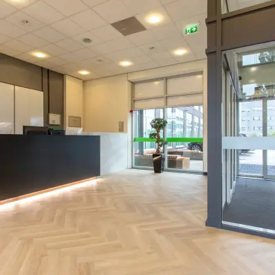 Spacious reception area at the office for rent on Louis Braillelaan 80, Zoetermeer, featuring modern design and elegant flooring. Ideal for office space rental needs.