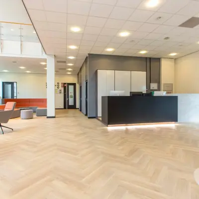 Bright office reception area at Louis Braillelaan 80 in Zoetermeer, offering a sleek office space rental opportunity with modern furnishings and welcoming design.