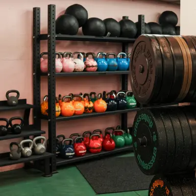 A fitness area within an office space for rent at Beethovenstrasse 48, Zürich Enge, featuring kettlebells, weight plates, and shelving.