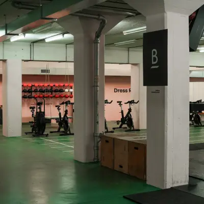 A well-lit interior at Beethovenstrasse 48, Zürich Enge, suitable for office space rental, featuring open areas and exercise equipment.
