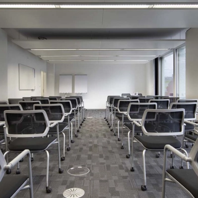 Modern office space with rows of chairs facing whiteboards and large windows, ideal for training sessions or presentations at Europaallee 41.