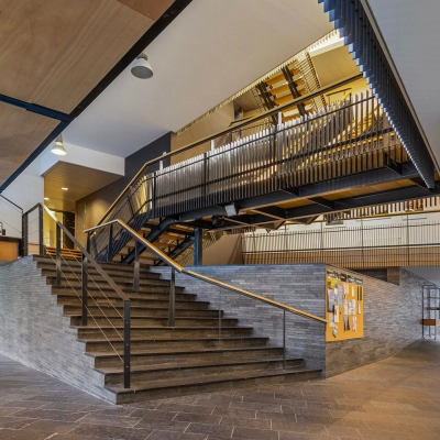 Spacious interior of an office space rental at Assendorperdijk 1, Zwolle, featuring modern architectural design with a striking staircase, ideal for a dynamic office to rent.