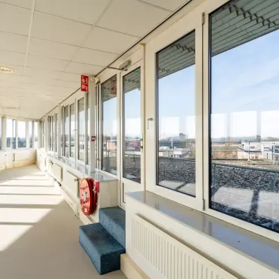 Bright office hall with large windows and city view, ideal for office space rental in Zwolle.
