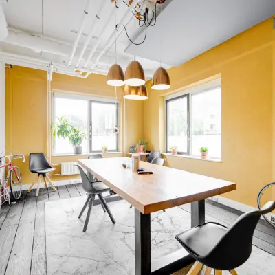 Bright office space at Hanzeplein 11-27, Zwolle with a wooden table, chairs, and decorative bicycles, ideal for office space rental.