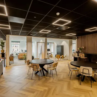 Modern office space available for rent at Zuiderzeelaan 15-25, Zwolle, featuring round tables and chairs under stylish lighting.