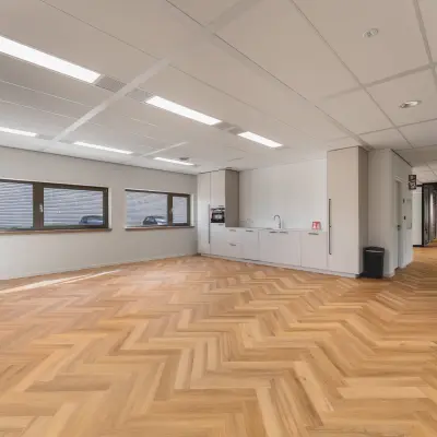 Lichte kantoorruimte op Veluwezoom 15 in Almere Stad met visgraat houten vloer, ingebouwde keuken en grote ramen. Ideaal voor wie een kantoorruimte wil huren.