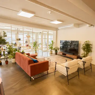 Moderne kantoorruimte huren op Kleine Gartmanplantsoen 21 in Amsterdam Centrum, met een stijlvolle lounge met comfortabele zitplaatsen en planten. Ruimte geschikt voor comfortabel werken en ontspannen.