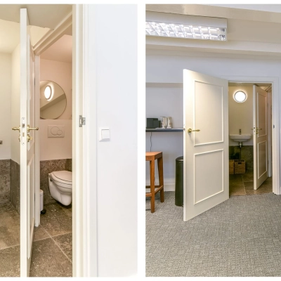 Kantoorruimte huren op Herengracht 338, Amsterdam Grachtengordel, met een functionele inrichting. De ruimte bevat een bureau en stoel, en is voorzien van een aangrenzende sanitaire faciliteit.