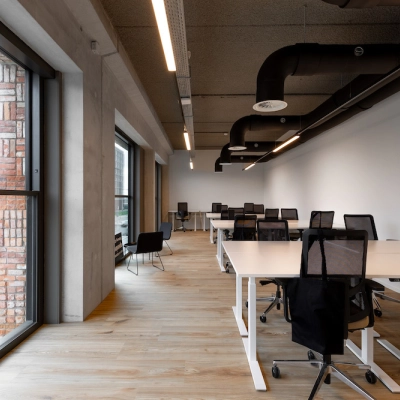 Ruime kantoorruimte aan Papaverhof 58 in Amsterdam Noord met grote ramen, moderne bureaus en comfortabele stoelen. Ideaal voor het huren van een kantoorpand voor verschillende zakelijke activiteiten.