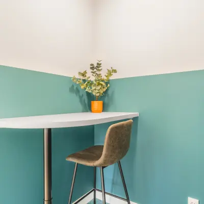 Gezellige hoek van een kantoorpand aan de Paasheuvelweg 20 in Amsterdam Zuid-Oost met een hoge tafel en stoel, ideaal voor informeel werken of pauzes. Perfect voor kantoorruimte huren.