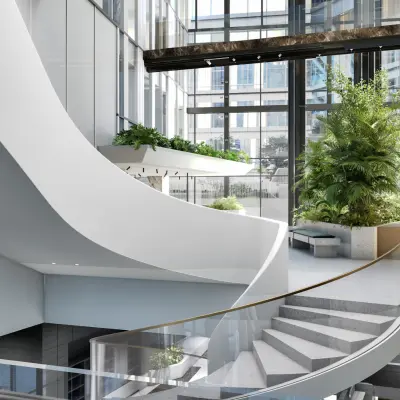 Moderne open kantoorruimte op de Claude Debussylaan 80-134 in Amsterdam Zuidas met veel natuurlijk licht, glazen balustrades en groene planten. Perfect voor kantoorruimte huren in een stijlvol kantoorpand.