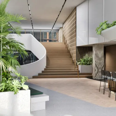 Moderne entree bij kantoorpand aan de Claude Debussylaan 80-134, Amsterdam Zuidas, met veel groen en stijlvolle trap, ideaal voor bedrijven om kantoorruimte te huren.