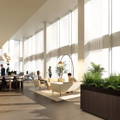 Moderne kantoorruimte in Amsterdam Zuidas met grote ramen, stijlvolle meubels en mensen in gesprek. Ideaal om te huren met veel licht en groen. Gelegen op Claude Debussylaan 80-134.