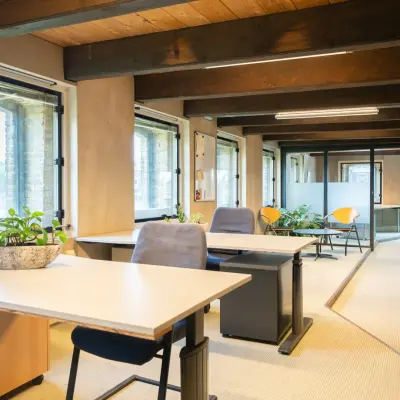 Kantoorruimte huren op Prins Hendrikkade 3 in Franeker met houten details, moderne bureaus en grote ramen met uitzicht over de stad.