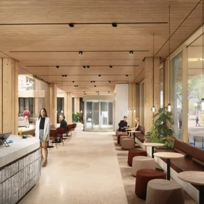 Moderne kantoorruimte huren aan de Coolsingel 75 in Rotterdam Centrum, met een open en lichte werkruimte waar mensen aan tafels zitten en zakelijke activiteiten uitvoeren.