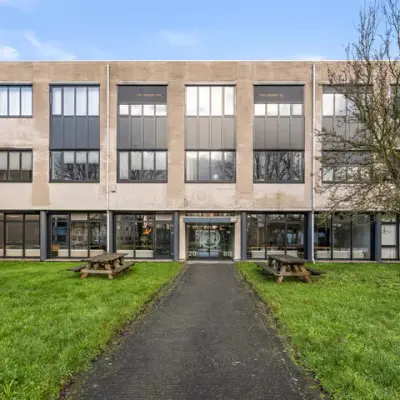 Vooraanzicht van kantoorpand aan Agro Business Park 22 in Wageningen met praktische uitstraling en groene grasvelden. Ideaal voor wie kantoorruimte wil huren in een functioneel ingericht pand.